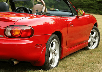 Mazda Miata paint with restored color, gloss, and depth after polishing.